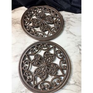 2~CAST IRON TRIVETS ROUND WITH HEART AND FOUR LEAF CLOVER 7" D (2869)